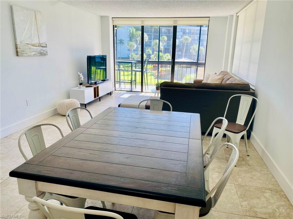 601 Seaview Court, Unit C208 Marco Island, FL 34145 - Photo 5 of 16 a living room with furniture and a floor to ceiling window