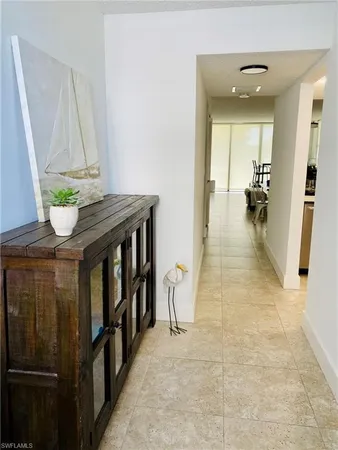 a hallway with cabinets and wooden floor