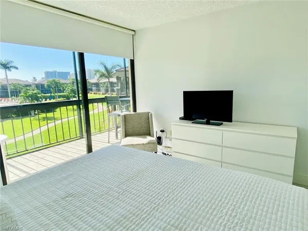 a view of a terrace with hardwood floor and a flat screen tv