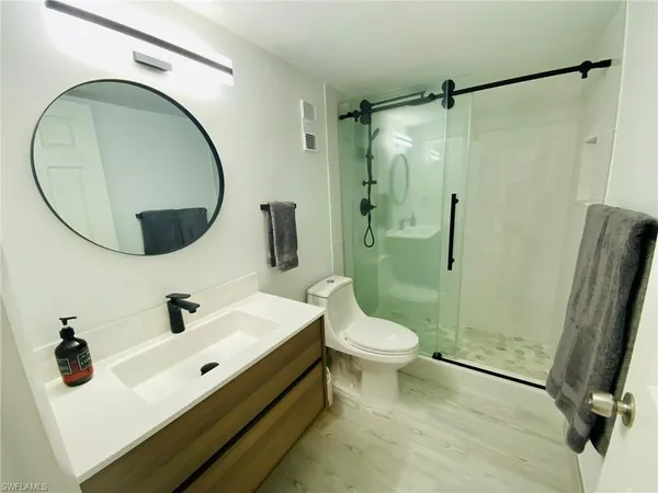 a bathroom with a sink toilet and shower