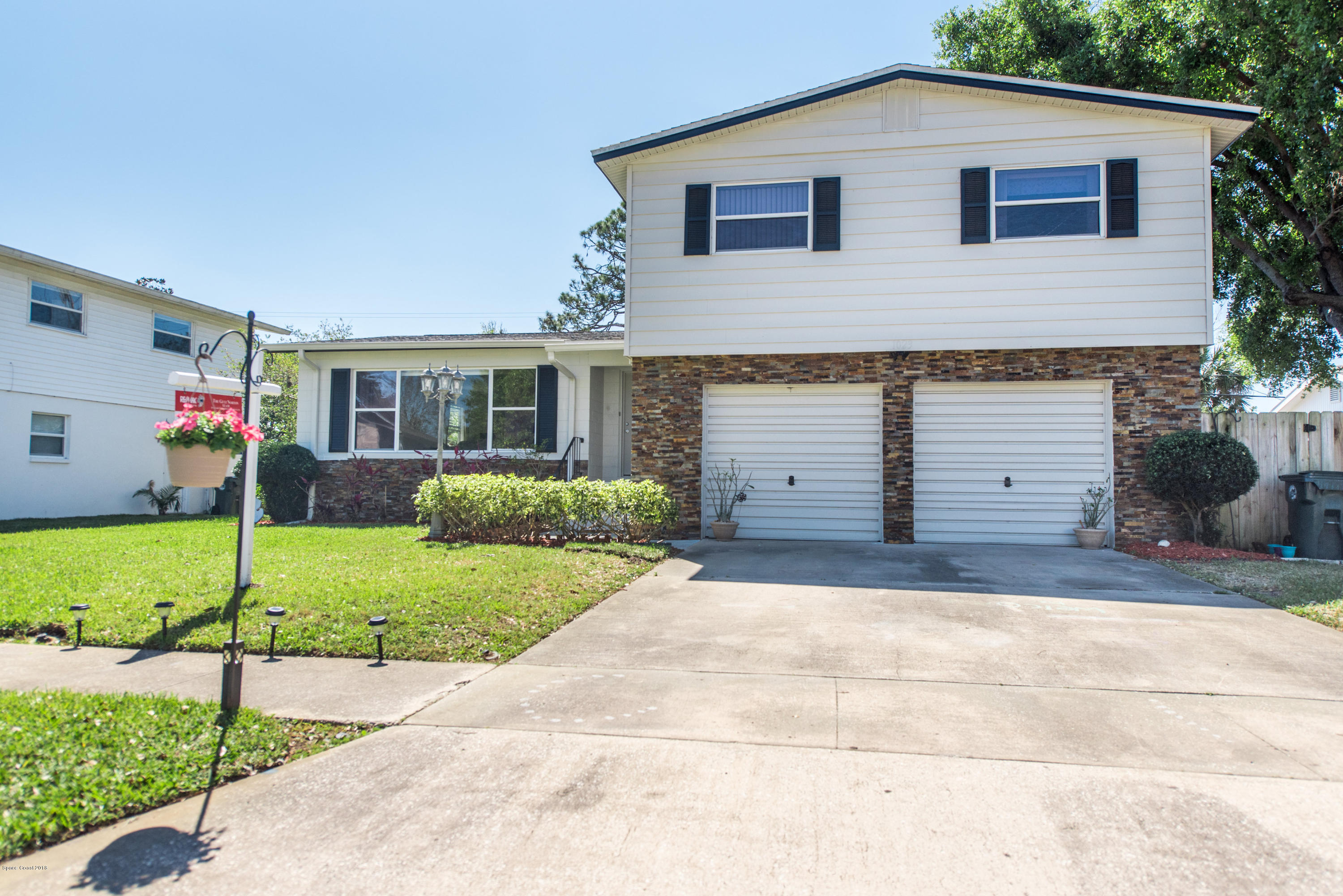 1023 Palmer Road Rockledge, FL 32955 - Photo 1 of 24 a front view of a house with a yard and garage