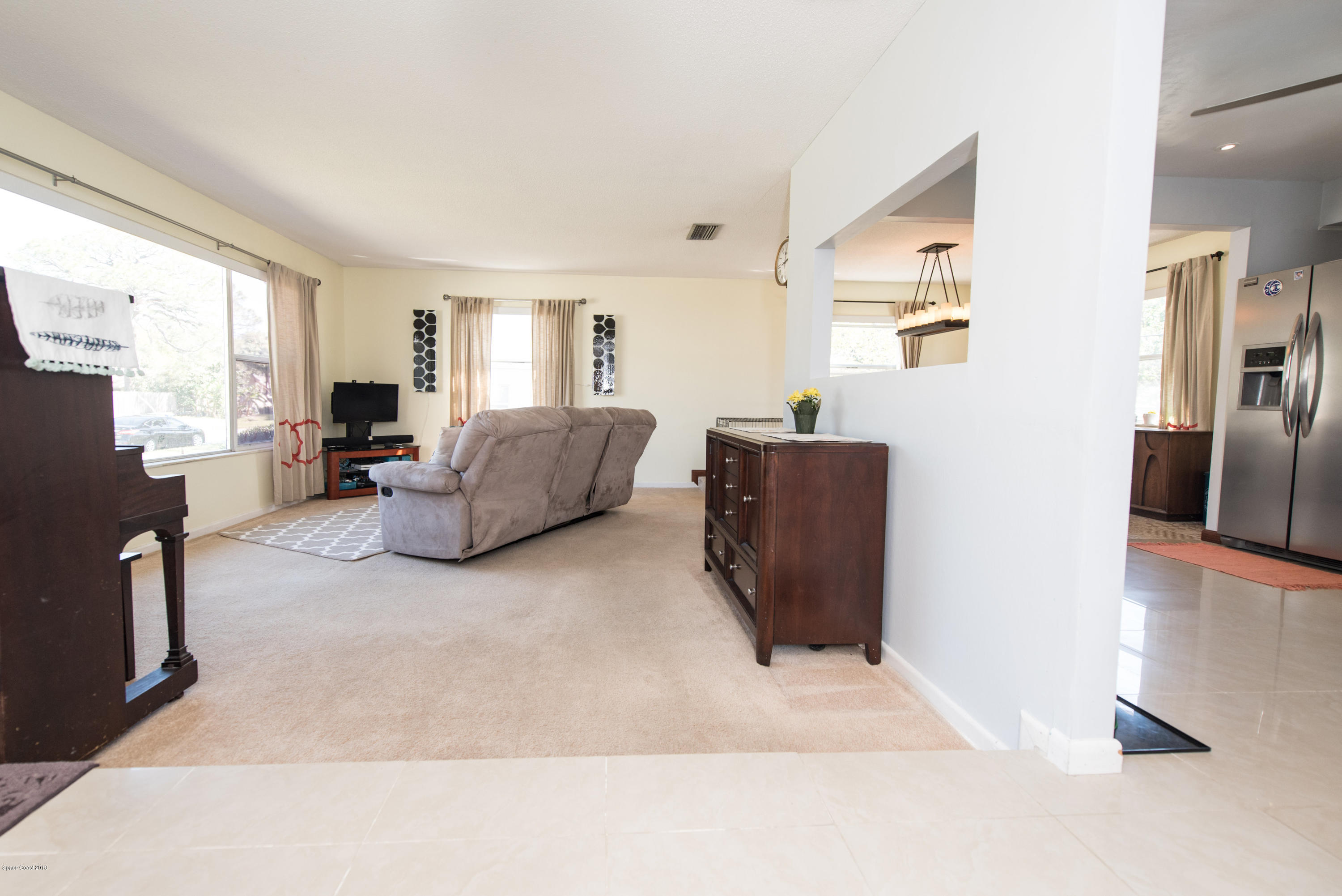 1023 Palmer Road Rockledge, FL 32955 - Photo 11 of 24 a living room with furniture and a flat screen tv