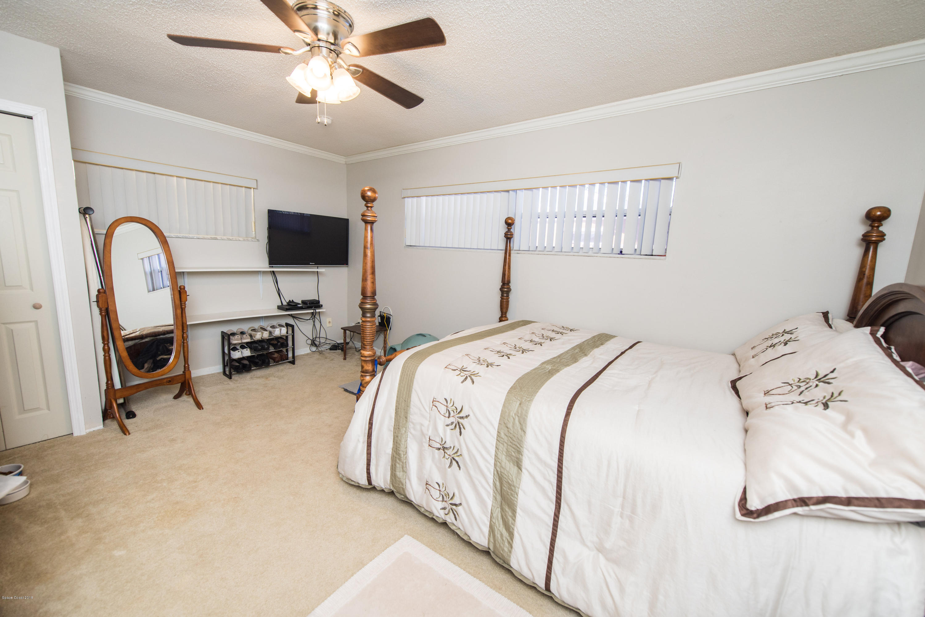 1023 Palmer Road Rockledge, FL 32955 - Photo 13 of 24 a bed room with a bed and a television
