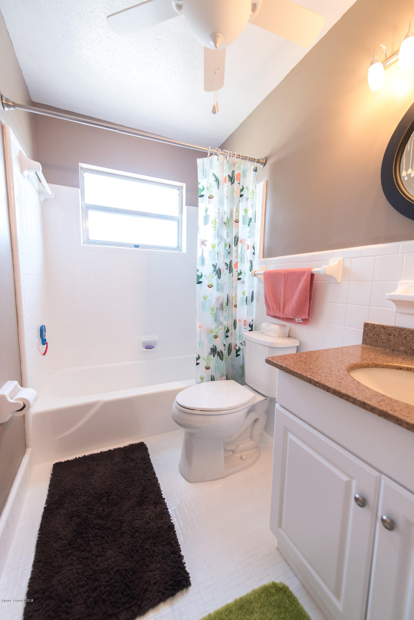 1023 Palmer Road Rockledge, FL 32955 - Photo 18 of 24 a bathroom with a sink a toilet a tub and shower