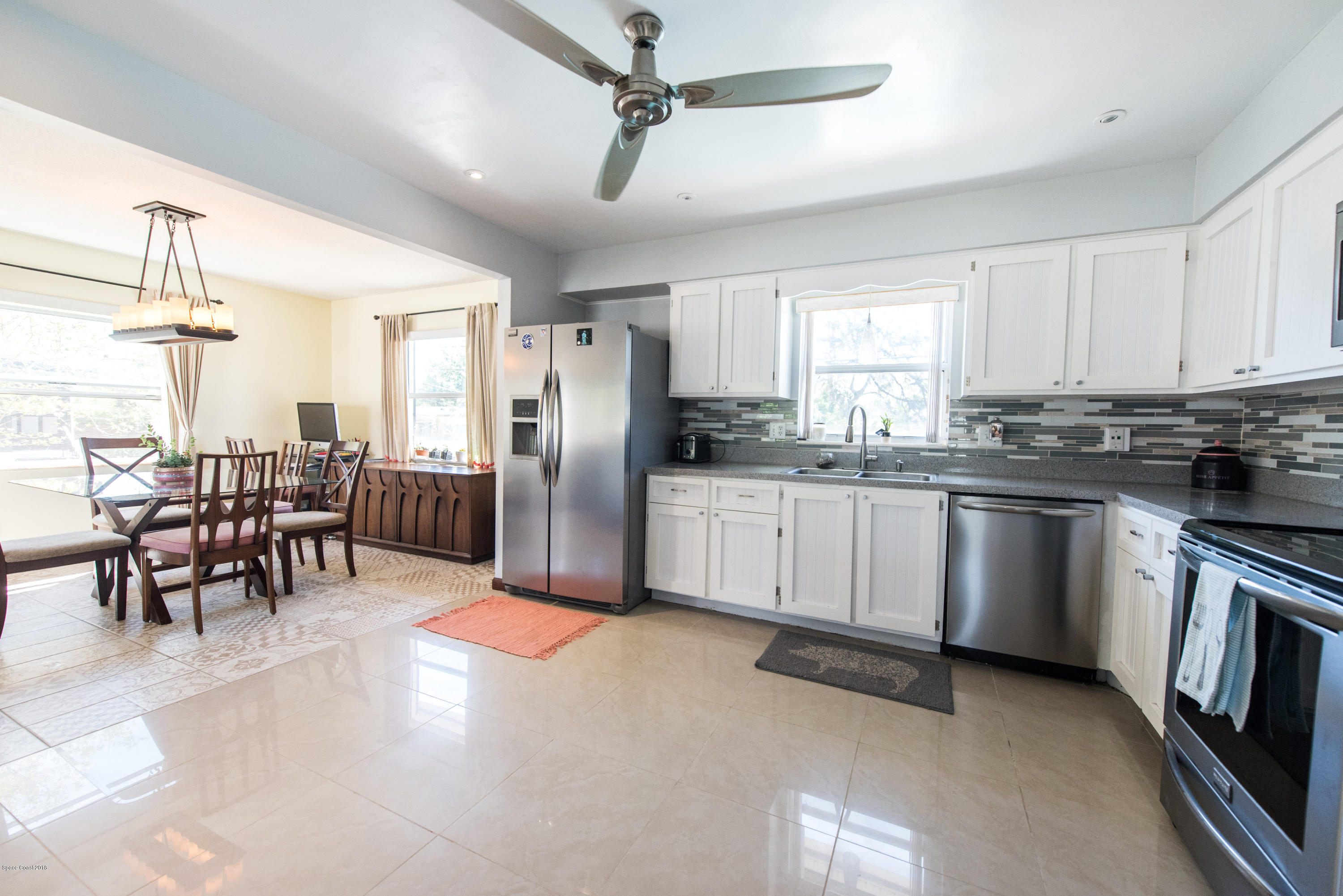 1023 Palmer Road Rockledge, FL 32955 - Photo 4 of 24 a kitchen with granite countertop stainless steel appliances a sink counter space and a window