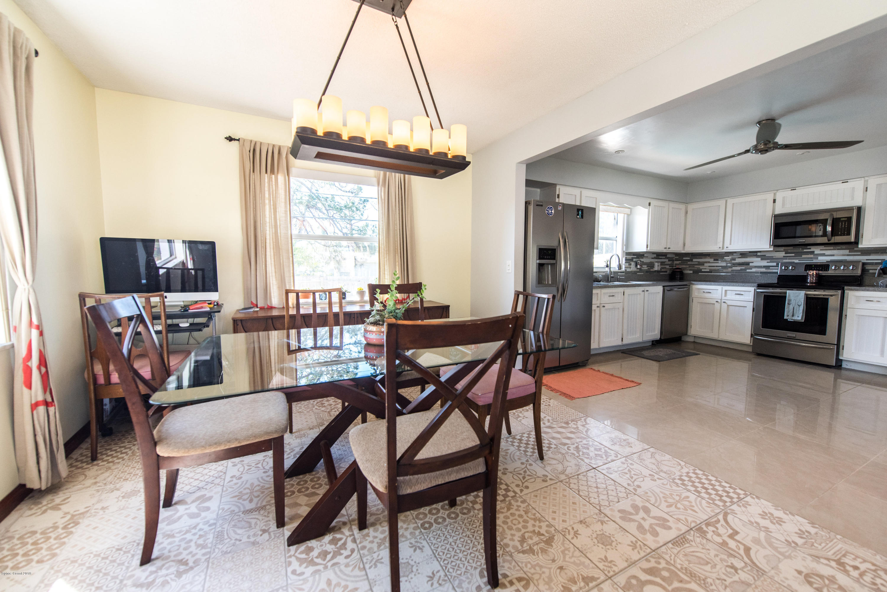 1023 Palmer Road Rockledge, FL 32955 - Photo 5 of 24 a view of a dining room with furniture window and wooden floor