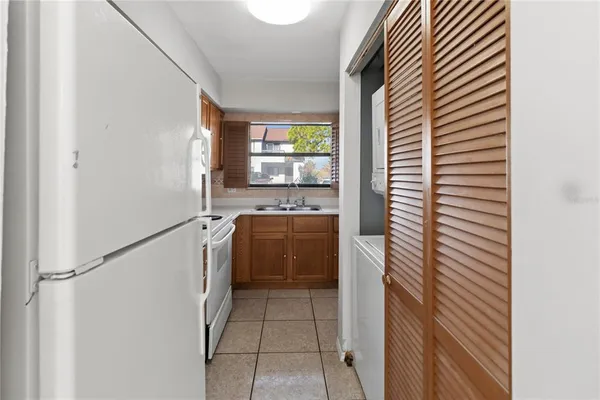 a kitchen with a refrigerator and a stove