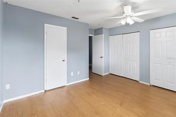 an empty room with fan and a ceiling fan
