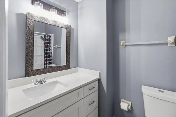 a bathroom with a sink a toilet and mirror