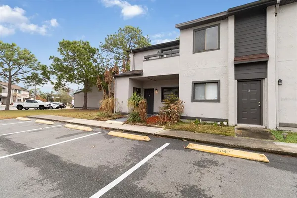 a view of a house with a swimming pool and a dining table and chairs