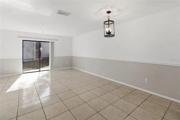an empty room with windows and cabinet