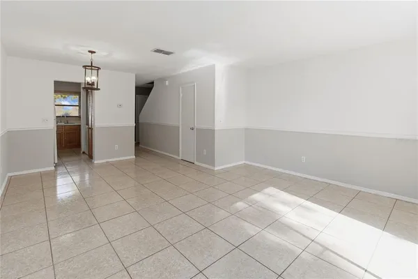 a view of a kitchen with a sink and a refrigerator