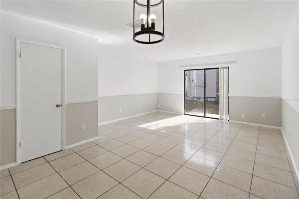 an empty room with windows and cabinet