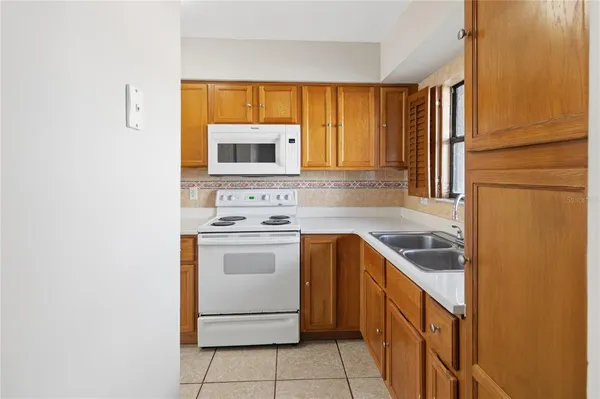 a kitchen with a stove sink and microwave