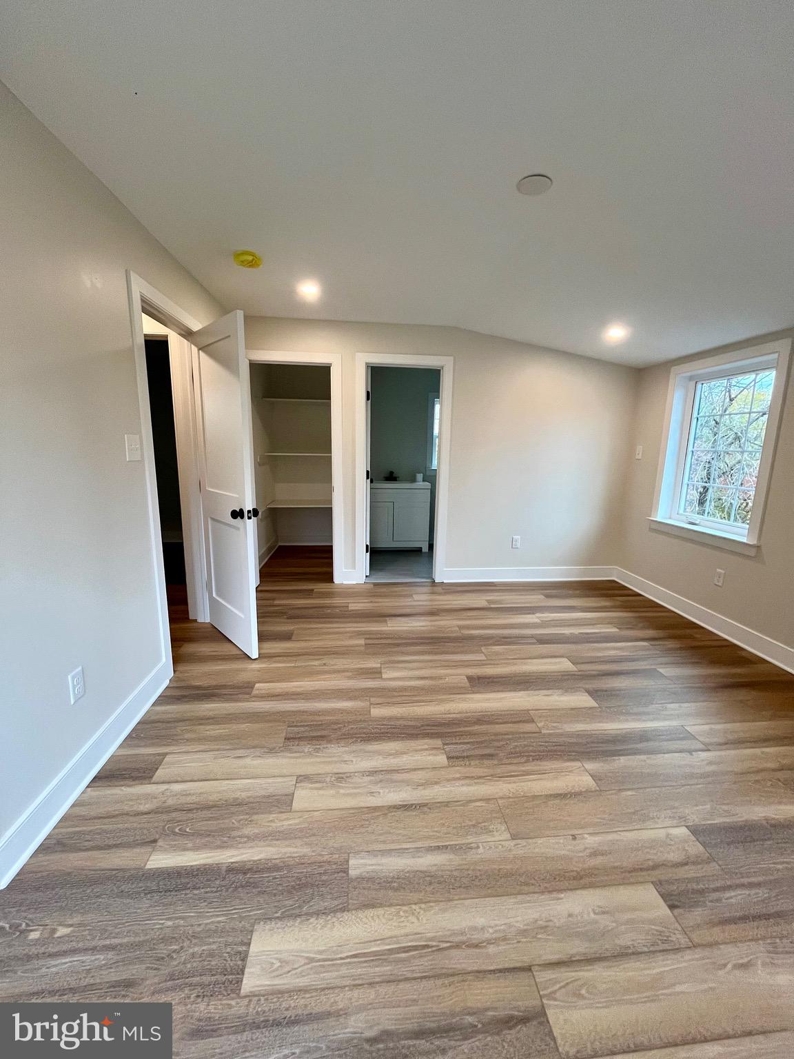 135 Center Hill Road Upper Black Eddy, PA 18972 - Photo 16 of 25 an empty room with wooden floor and windows