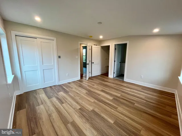 a view of a livingroom with wooden floor and closet