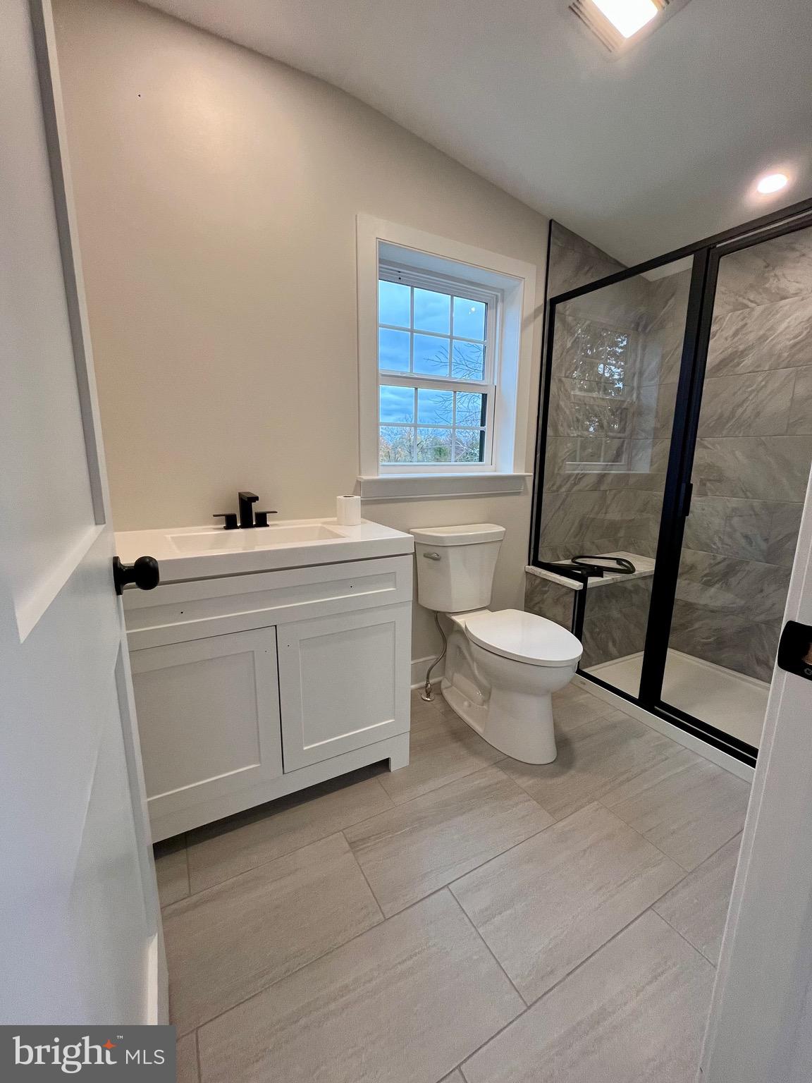 135 Center Hill Road Upper Black Eddy, PA 18972 - Photo 19 of 25 a bathroom with a sink toilet and window