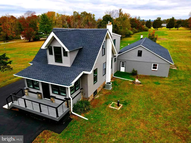 a aerial view of a house with swimming pool and a yard