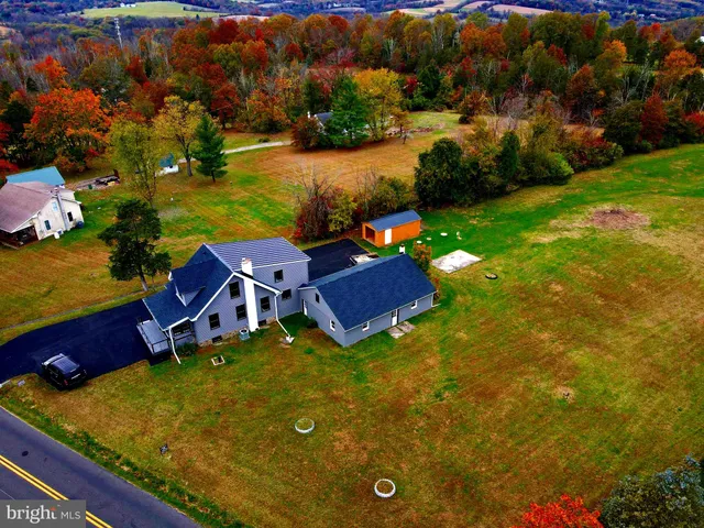 an aerial view of residential houses with yard