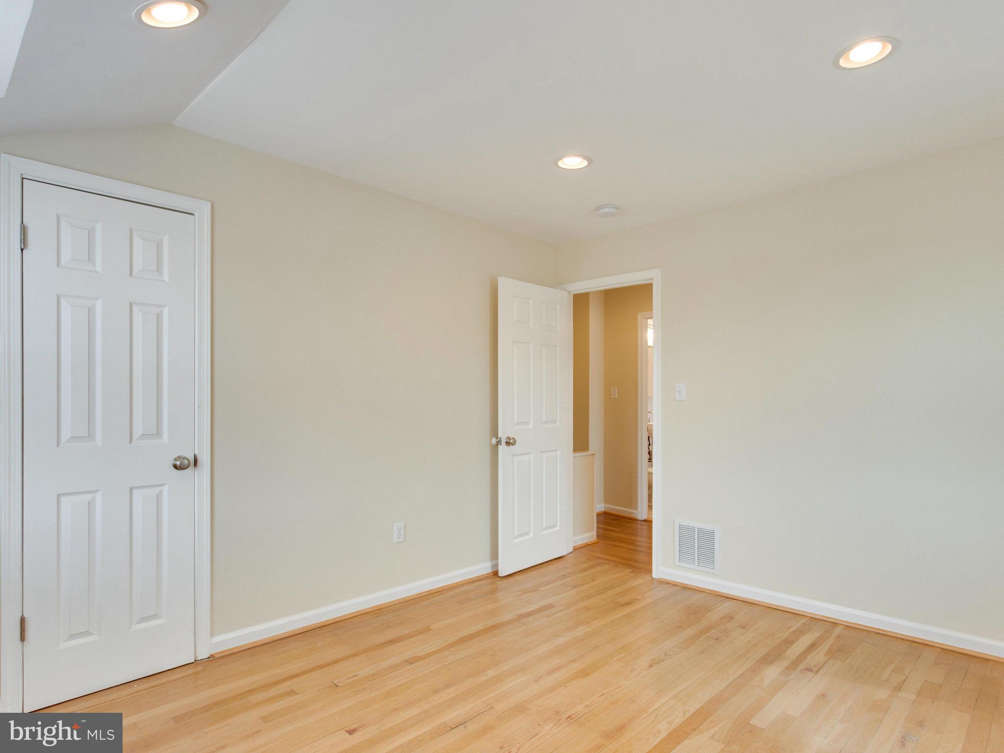 5131 Sheriff Road Northeast Washington, DC 20019 - Photo 12 of 29 a view of an empty room with wooden floor