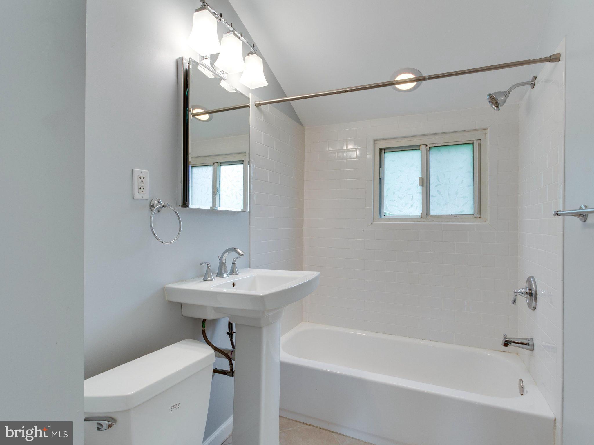 5131 Sheriff Road Northeast Washington, DC 20019 - Photo 15 of 29 a bathroom with a sink a toilet and shower