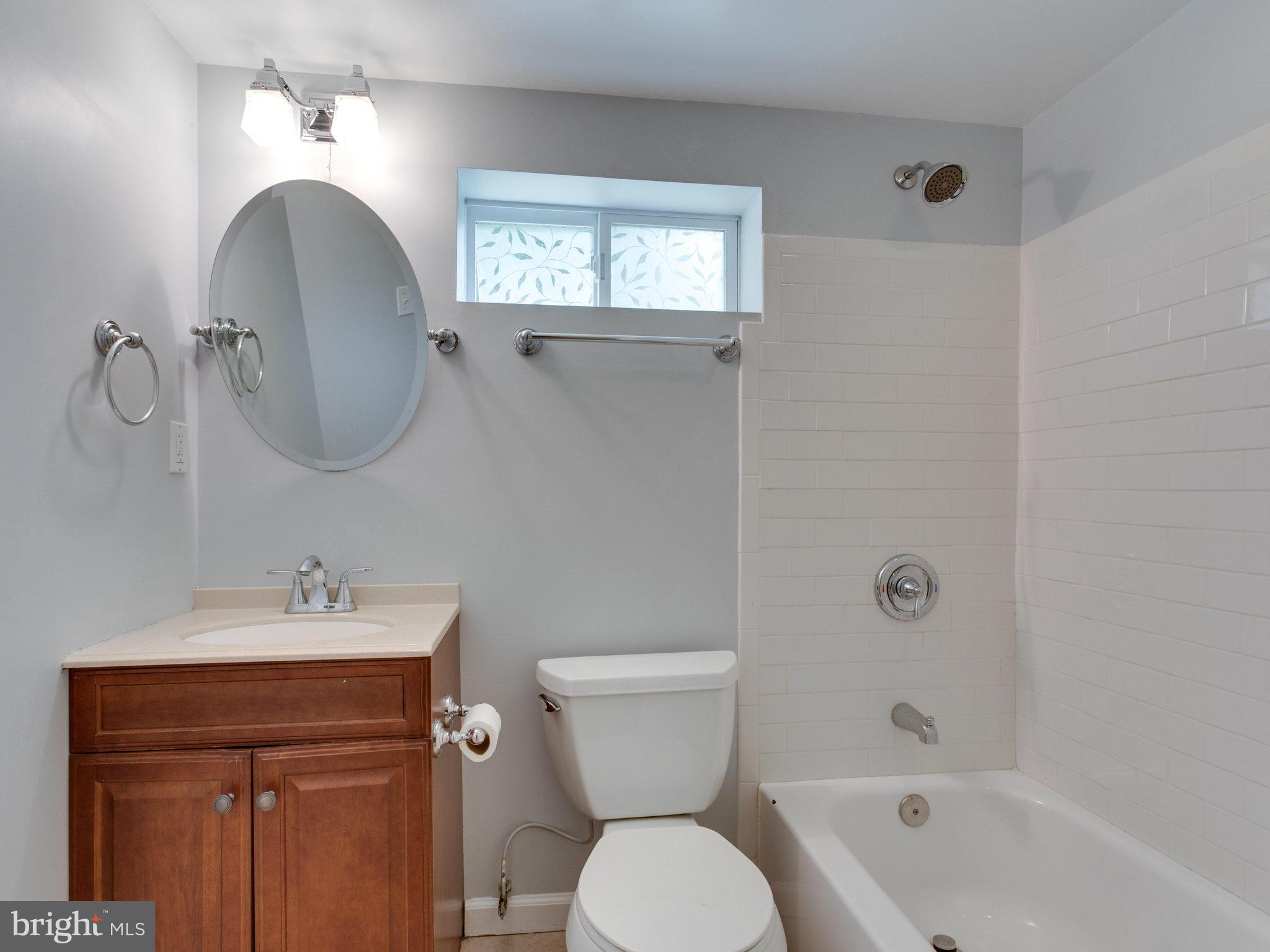 5131 Sheriff Road Northeast Washington, DC 20019 - Photo 23 of 29 a bathroom with a sink toilet and shower