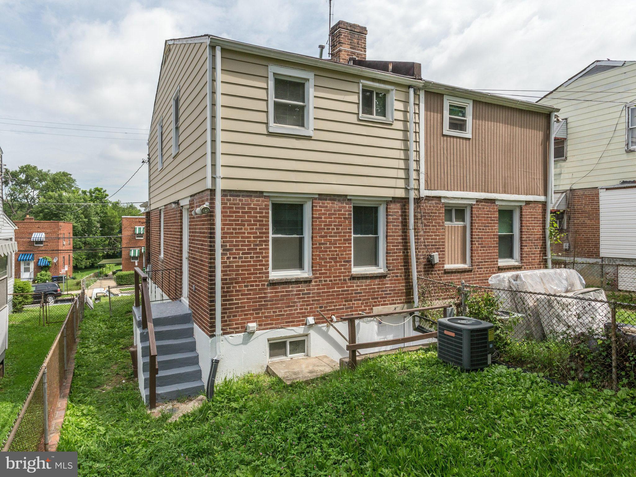 5131 Sheriff Road Northeast Washington, DC 20019 - Photo 25 of 29 a front view of a house with a yard outdoor seating and barbeque oven
