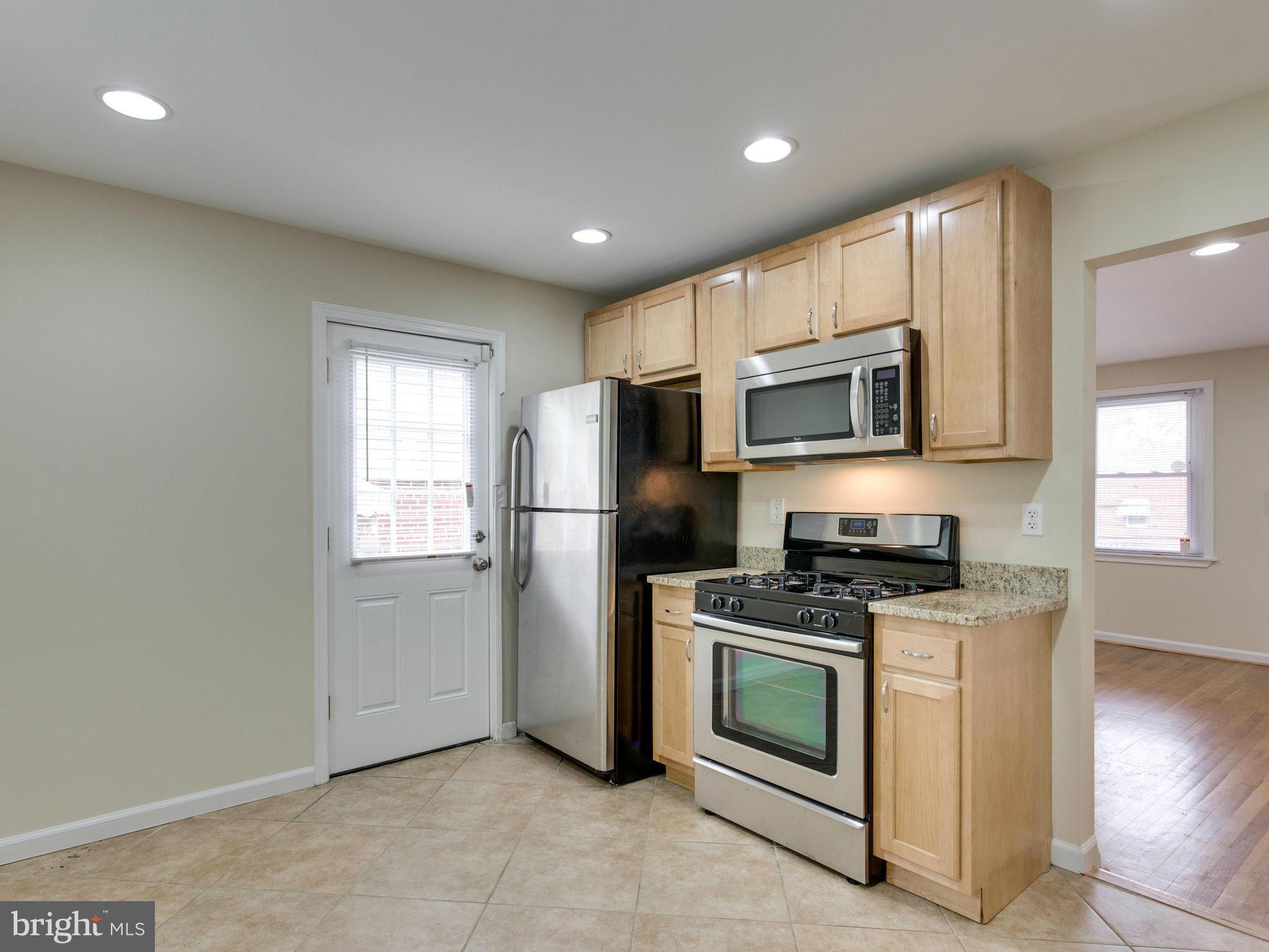 5131 Sheriff Road Northeast Washington, DC 20019 - Photo 9 of 29 a kitchen with a refrigerator stove and microwave