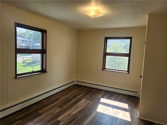 a view of an empty room and wooden floor