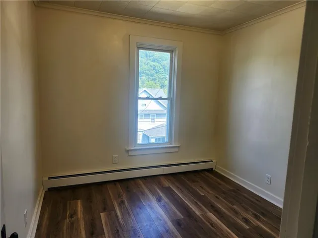 a view of an empty room and wooden floor