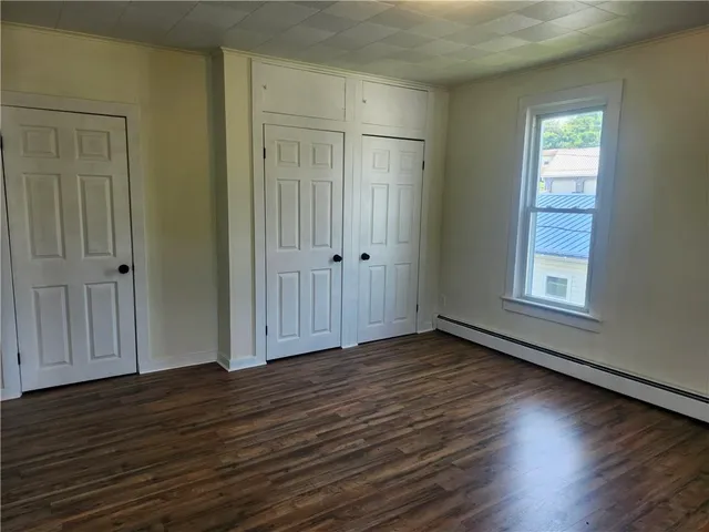 a view of a room with wooden floor