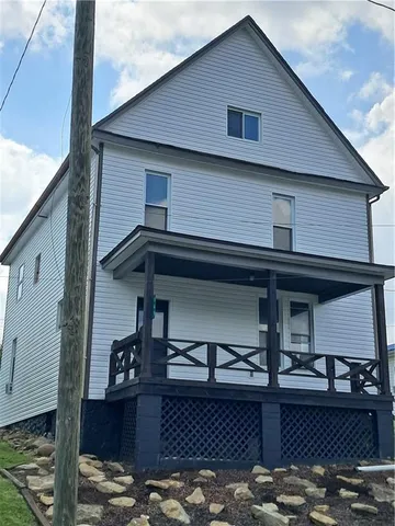 a front view of a house with parking space