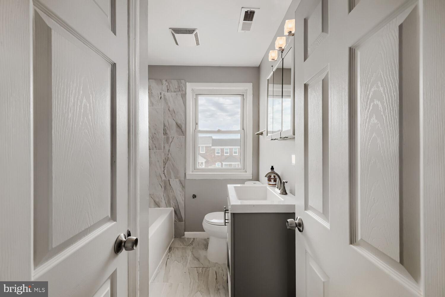 1014 Lyndhurst Street Baltimore, MD 21229 - Photo 21 of 29 a bathroom with a sink toilet and shower