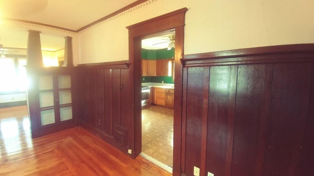 124 Phoenix Terrace Springfield, MA 01104 - Photo 2 of 17 a view of a porch with wooden floor and a door