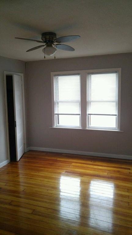 124 Phoenix Terrace Springfield, MA 01104 - Photo 10 of 17 a view of an empty room with wooden floor and a window