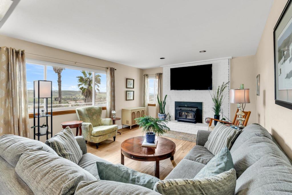 13501 Melissa Lane Poway, CA 92064 - Photo 23 of 62 a living room with furniture a fireplace and a flat screen tv