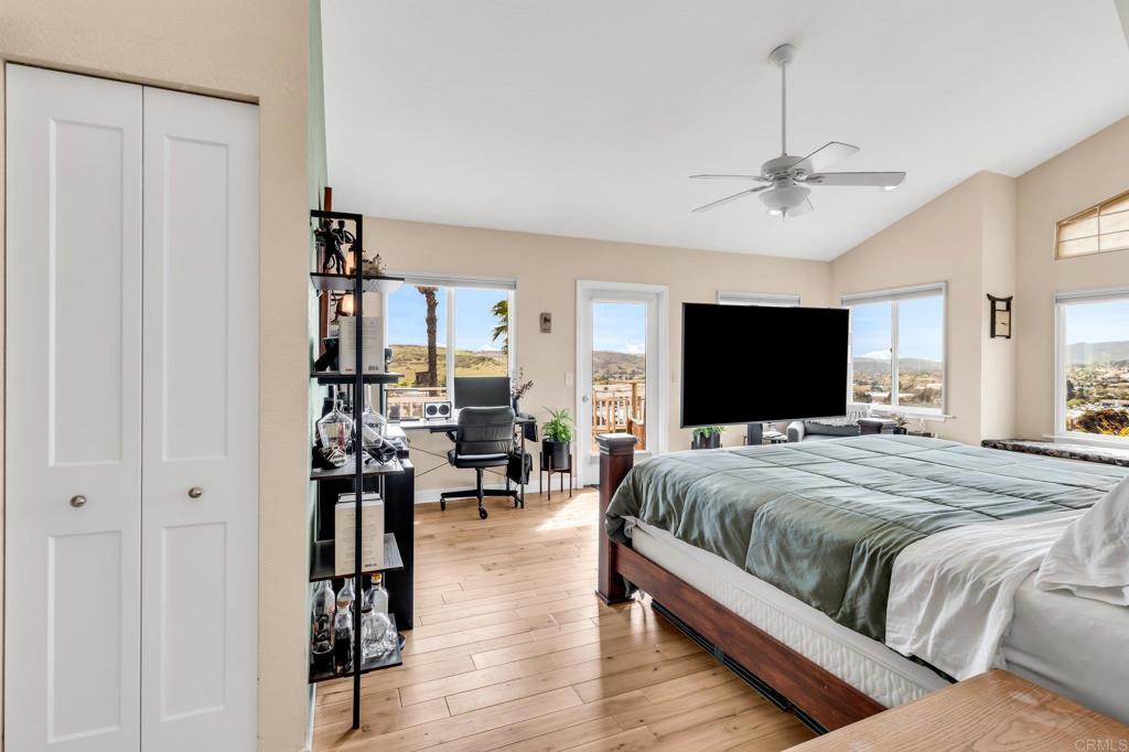 13501 Melissa Lane Poway, CA 92064 - Photo 25 of 62 a spacious bedroom with a bed and a flat screen tv