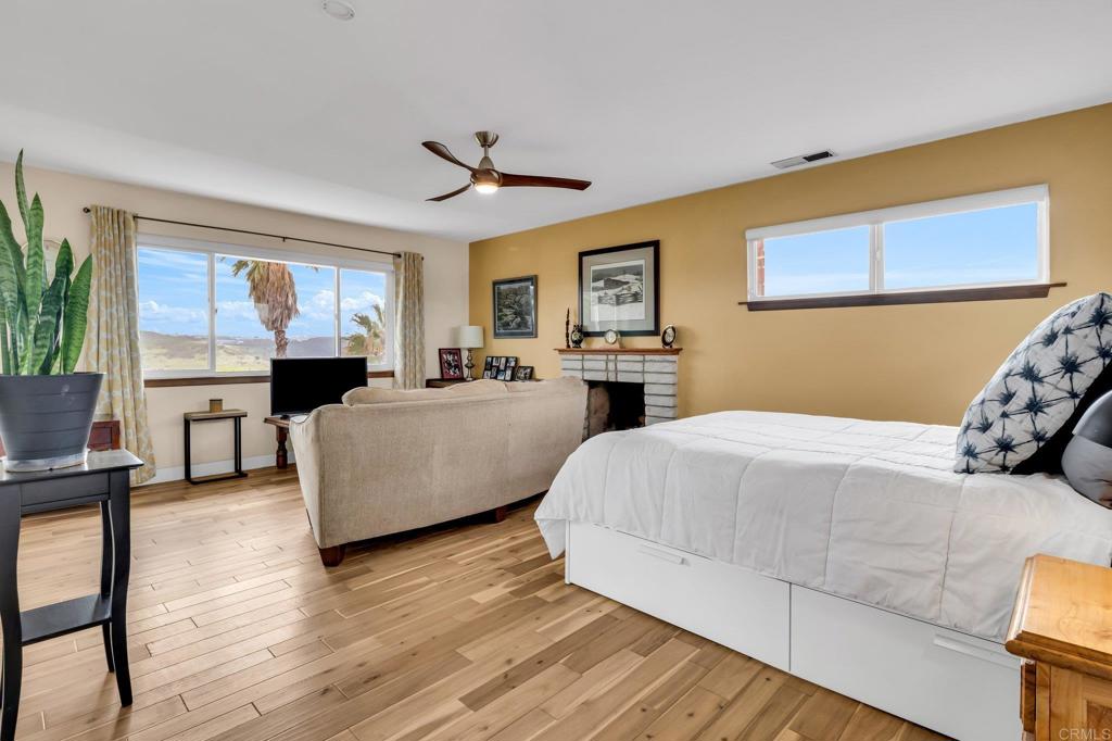 13501 Melissa Lane Poway, CA 92064 - Photo 33 of 62 a spacious bedroom with a bed and a table