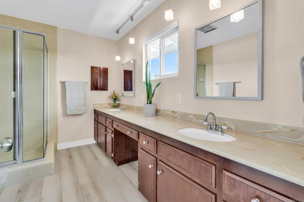 13501 Melissa Lane Poway, CA 92064 - Photo 36 of 62 a spacious bathroom with a double vanity sink a mirror and a