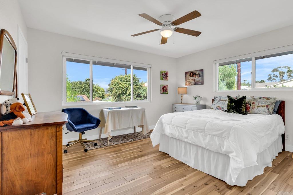 13501 Melissa Lane Poway, CA 92064 - Photo 40 of 62 a bedroom with a bed a chair and a large window