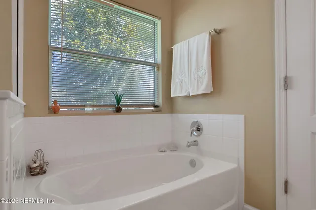 a spacious bedroom with a bed and a window