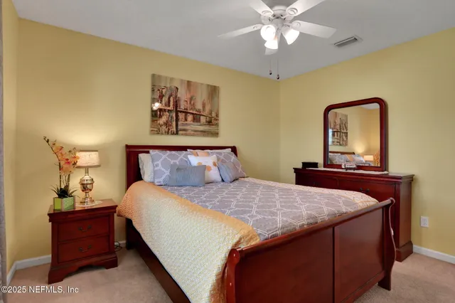 a bathroom with a sink toilet a mirror and shower curtain