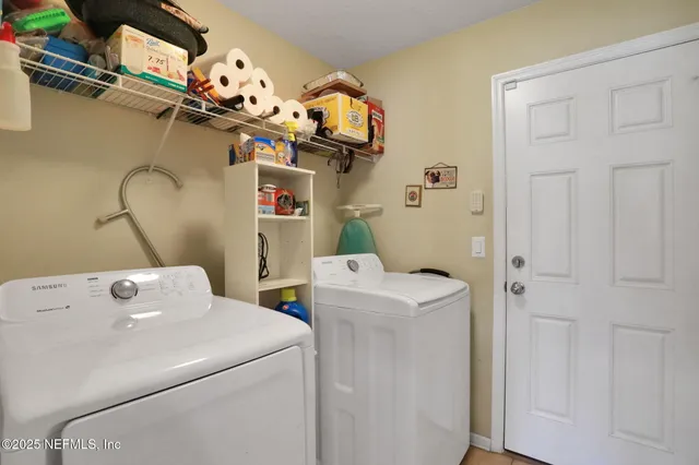 a dining room with furniture potted plants and wooden floor