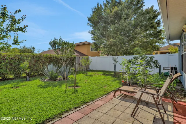 a front view of a house with yard and green space