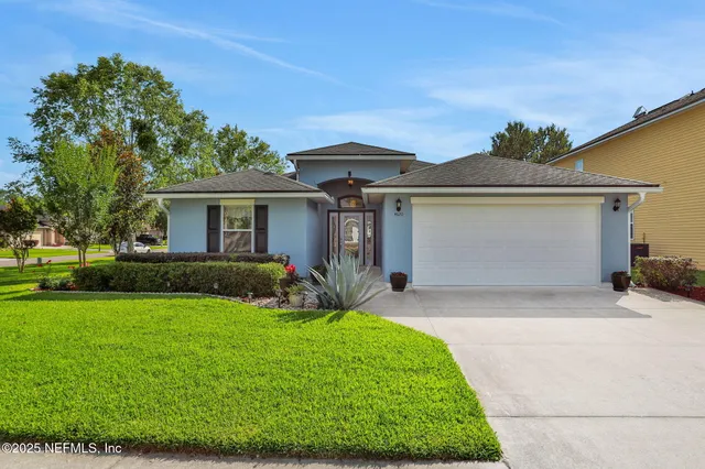 an aerial view of a house with garden space and lake view