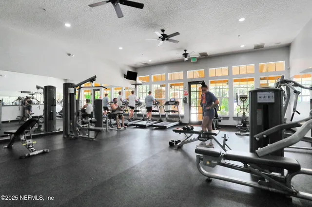 an aerial view of a house with swimming pool and large trees