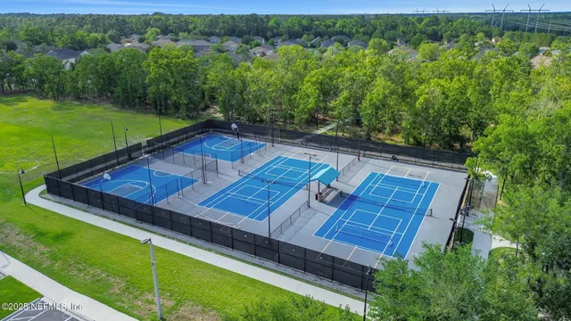 an aerial view of a house having patio with dining table and chairs