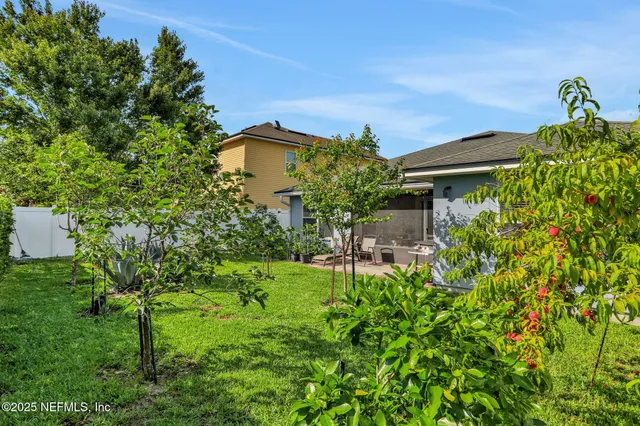 a backyard of a house with table and chairs