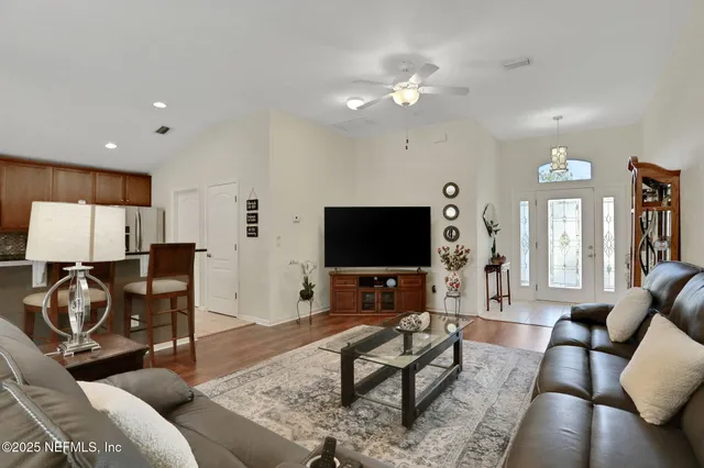 a living room with furniture and a flat screen tv