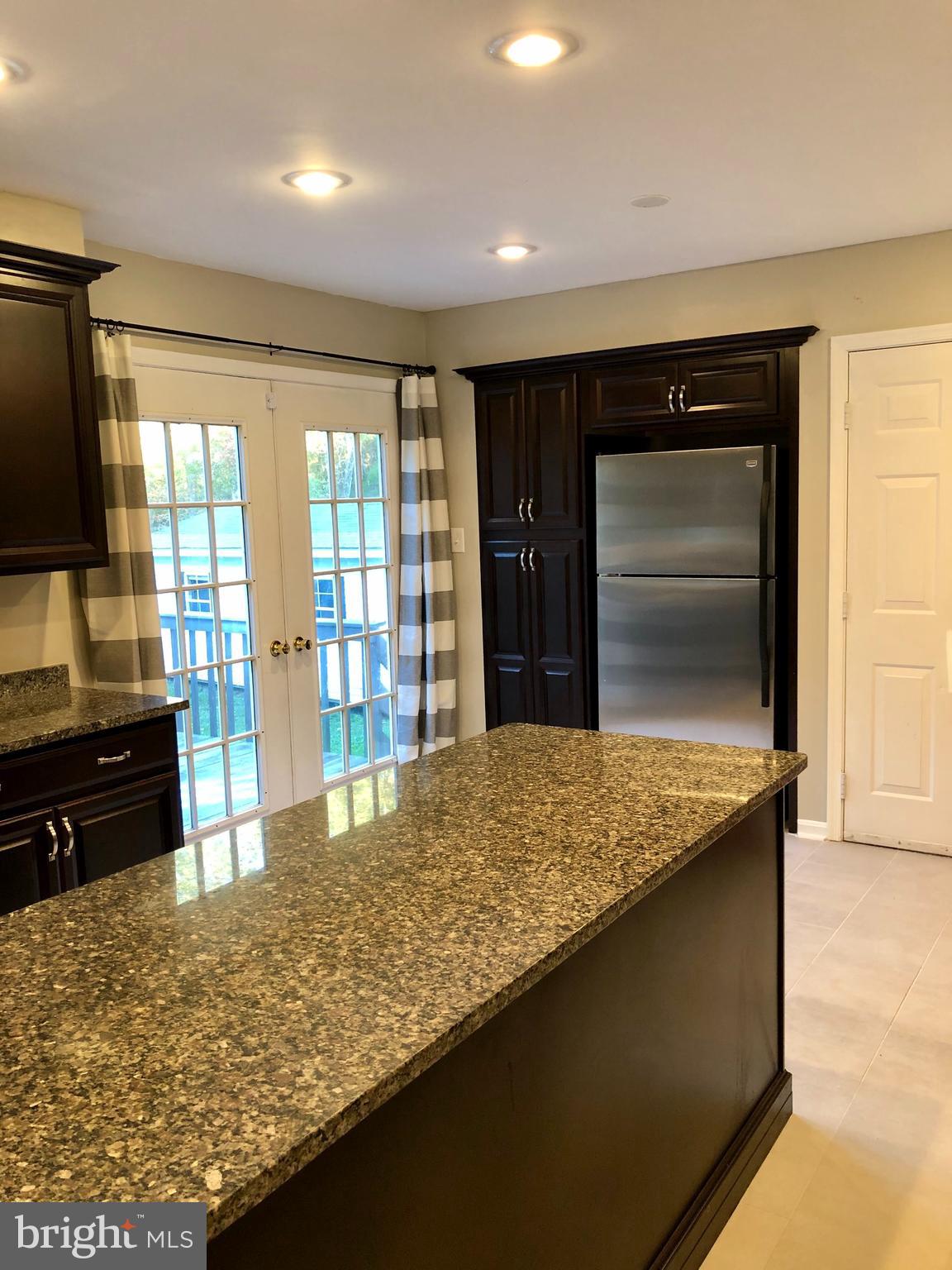 Kitchen with back door leading to the deck